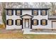 Charming two-story home featuring a fresh white paint, black shutters, and an attached garage at 2328 Carnes Rd, Jonesboro, GA 30236