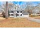 Charming two-story home featuring a fresh white paint, black shutters, and an attached garage at 2328 Carnes Rd, Jonesboro, GA 30236