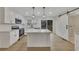 Modern kitchen featuring stainless steel appliances, an island, and a barn door to the laundry at 2328 Carnes Rd, Jonesboro, GA 30236