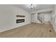 Spacious living room with wood-look floors, white walls, a modern fireplace, and ample natural light at 2328 Carnes Rd, Jonesboro, GA 30236