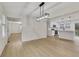 Open concept living room and kitchen area with hardwood floors and natural light at 2328 Carnes Rd, Jonesboro, GA 30236