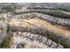 Aerial view of homes backing on golf course with wooded surroundings at 250 High Court Way, Locust Grove, GA 30248