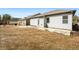 View of fenced backyard with grass and concrete patio area at 250 High Court Way, Locust Grove, GA 30248