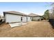 View of fenced backyard with grass and concrete patio between homes at 250 High Court Way, Locust Grove, GA 30248