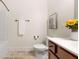 Cozy bathroom features stone-look tile, white counter, and decorative floral arrangement at 250 High Court Way, Locust Grove, GA 30248