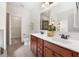 Bathroom vanity with double sinks, wood cabinetry, neutral walls, and tile floors at 250 High Court Way, Locust Grove, GA 30248