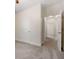 Bedroom with neutral carpet and trim, showing hallway through door at 250 High Court Way, Locust Grove, GA 30248
