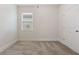 Neutral bedroom with plush carpeting, natural light, and white trim at 250 High Court Way, Locust Grove, GA 30248