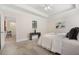 Bedroom view showcasing the carpet, adjacent room, and neutral color palette at 250 High Court Way, Locust Grove, GA 30248