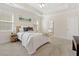 Cozy bedroom with a ceiling fan, bright windows, and neutral decor at 250 High Court Way, Locust Grove, GA 30248
