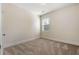 Bedroom with neutral walls, carpet flooring, and bright window at 250 High Court Way, Locust Grove, GA 30248