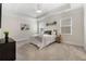 Bright bedroom featuring tray ceilings, neutral walls, and soft carpet flooring at 250 High Court Way, Locust Grove, GA 30248
