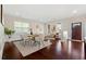 Bright dining room with hardwood floors, wainscotting, a modern table, and comfortable seating near the front door at 250 High Court Way, Locust Grove, GA 30248