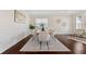 Bright dining room featuring dark hardwood floors, a stylish rug, and modern decor, creating a cozy atmosphere at 250 High Court Way, Locust Grove, GA 30248