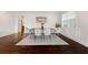Bright dining room features hardwood floors, white trim and seating for six around a wooden table at 250 High Court Way, Locust Grove, GA 30248