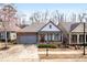 Well-maintained home with stone accents, neutral siding, a welcoming entrance, and mature landscaping in daylight at 250 High Court Way, Locust Grove, GA 30248