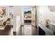 Bright foyer with hardwood floors, white wainscoting, and view of landscaped front yard at 250 High Court Way, Locust Grove, GA 30248