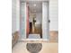 Inviting entryway with an open door, stone accents, and welcome mat at 250 High Court Way, Locust Grove, GA 30248