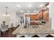 Open-concept kitchen with granite countertops, hardwood floors and stainless steel appliances at 250 High Court Way, Locust Grove, GA 30248