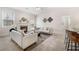 Comfortable living room with a fireplace, modern sofas, and seamless transition into the kitchen at 250 High Court Way, Locust Grove, GA 30248