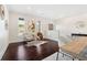 Open-concept living room with hardwood floors, natural light, and stylish decor at 250 High Court Way, Locust Grove, GA 30248
