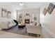 Bright living room with vaulted ceilings, a fireplace, neutral decor, and modern furnishings at 250 High Court Way, Locust Grove, GA 30248