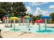 Fun splash pad with colorful mushroom-shaped sprinklers, providing a refreshing and playful water experience for families at 250 High Court Way, Locust Grove, GA 30248