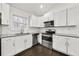 Kitchen with stainless appliances, white shaker cabinets and tile backsplash at 298 Harper Se Rd, Atlanta, GA 30315