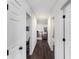 Hallway featuring hardwood floors and white doors at 424 Remington Ct, Villa Rica, GA 30180