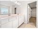 Bright bathroom featuring double sinks, large mirror, and walk-in closet at 500 Appalachian Pl, Canton, GA 30114