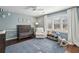 Bedroom with hardwood floors, soft blue walls, white curtains, and plantation shutters at 6785 Hunters Trace Cir, Atlanta, GA 30328