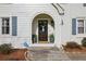 Inviting entryway features a classic wood door with wreath and potted ferns at 6785 Hunters Trace Cir, Atlanta, GA 30328