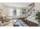 Cozy living room with hardwood floors, bright windows, and staircase at 6785 Hunters Trace Cir, Atlanta, GA 30328