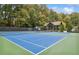 Community tennis courts with blue courts, covered seating, and mature trees surrounding the area at 6785 Hunters Trace Cir, Atlanta, GA 30328