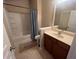 Bright bathroom featuring a tub with shower, neutral paint and a vanity with storage at 1426 Brookmere Way, Cumming, GA 30040