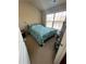 Simple bedroom featuring a bed with patterned bedding and a window providing natural light at 1426 Brookmere Way, Cumming, GA 30040