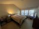 Bright bedroom with natural light, featuring a comfortable bed and views of the wooded area through the windows at 1426 Brookmere Way, Cumming, GA 30040