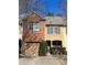 Charming townhouse featuring a brick facade and attached garage in a well-maintained community at 1426 Brookmere Way, Cumming, GA 30040