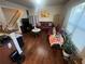 Cozy living room with hardwood floors, a plush red sofa, and abundant natural light from a large window at 1426 Brookmere Way, Cumming, GA 30040