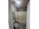 Bathroom with a shower-tub combo and white tile at 215 Bradley St, Covington, GA 30016
