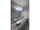 Modern bathroom featuring dual vessel sinks, granite countertop, and large vanity mirror at 215 Bradley St, Covington, GA 30016