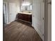 Modern bathroom with a double sink vanity, wood-look flooring, and ample storage space at 215 Bradley St, Covington, GA 30016