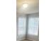 Bedroom featuring two large windows and natural light at 215 Bradley St, Covington, GA 30016