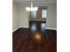 Dining room with hardwood floors, a chandelier, and an open archway to another room at 215 Bradley St, Covington, GA 30016