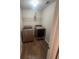 Laundry room equipped with modern washer and dryer units and wood grain flooring at 215 Bradley St, Covington, GA 30016