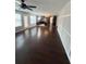 An open concept living area with hardwood floors and an adjacent kitchen offers an airy feel at 215 Bradley St, Covington, GA 30016