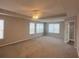 Expansive main bedroom with plush carpeting, tray ceilings, and natural light from large windows at 215 Bradley St, Covington, GA 30016