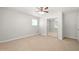 Bedroom featuring neutral walls, carpet, a ceiling fan and a mirrored closet at 3067 Orbit Cir, Ellenwood, GA 30294