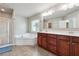 Bathroom with a shower, bathtub, and double vanity sinks, offering convenience and luxury at 615 Ceremony Way, Acworth, GA 30102