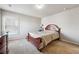 Comfortable bedroom features a wooden bed frame, plush carpet, and a dark dresser, ideal for relaxation at 615 Ceremony Way, Acworth, GA 30102